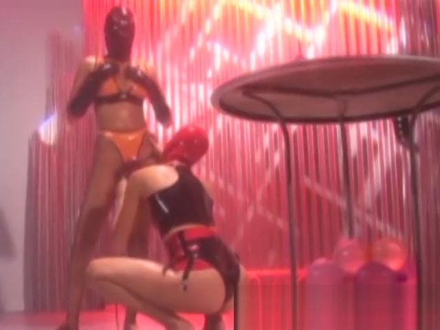 Masked latex subs toyed with by lesbian dominatrix